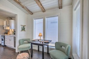 Cozy retreat with a dining area, kitchen view, and exposed beams.