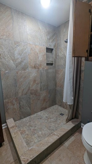 Shower, hair dryer, towels, toilet paper