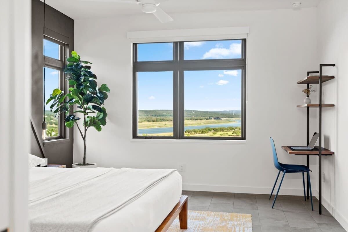 Upper primary bedroom with king bed, views, and workspace