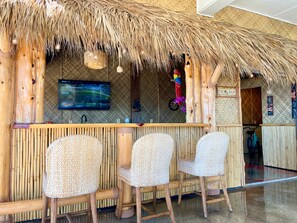 The Tiki Bar has an ice maker, beverage fridge, sink, large TV and games.