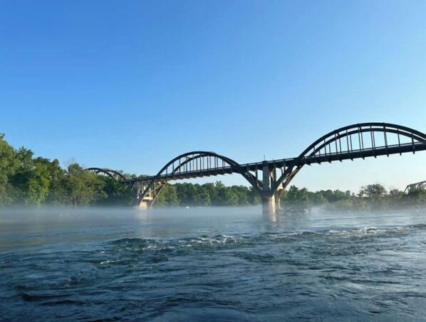 A bridge over a river with mist rising from the water. - New! Beautifully updated private home near White River and Bull Shoals (Flippin)