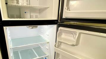 An open refrigerator with multiple shelves and compartments.