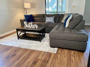 A living room with a sectional sofa, a coffee table, and a rug. - Summer Vaca Dates Going Fast! Sleeps 6, Pool, Beach, Golf (Calabash)