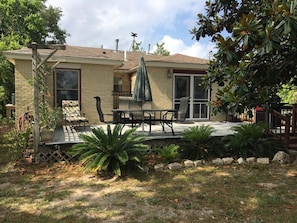 A house with a patio, outdoor furniture, and a covered seating area.