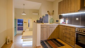 A modern kitchen with wooden cabinets, a microwave, and an oven.