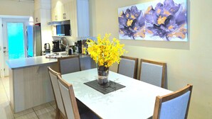A modern kitchen with a dining area.