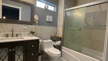 Combined shower/tub, hair dryer, towels, soap