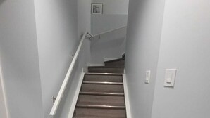 A staircase with wooden steps and white walls.