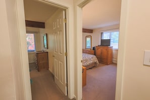 A bedroom with a bed, dresser, TV, and a window. - Official Seasons RMC Condo 17D- 2 Bedrooms - Sleeps 6 - No Fees (Bartlett)