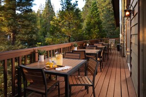 Enjoy dining or socializing on the deck, surrounded by lush greenery and scenic views.