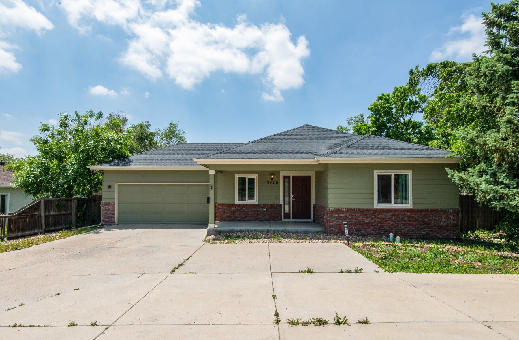 A single-story house with a garage, a front porch, and a well-maintained lawn.
