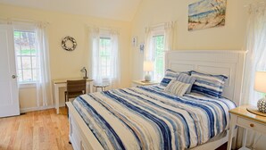 A bedroom with a bed, a desk, a chair, and a window. - New construction within 1 mile of bay beach and Nickerson Park (Brewster)