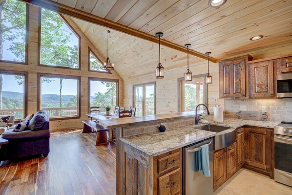 Enjoy cooking in this well-equipped kitchen with a large island, granite countertop, and stainless steel appliances.