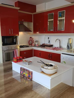 Enjoy cooking in this well-equipped kitchen with a gas stove, microwave, and dishwasher.