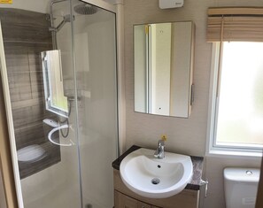 Shower, hair dryer, towels, toilet paper