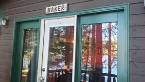 A wooden building with a sign reading "BAKER" above the entrance.