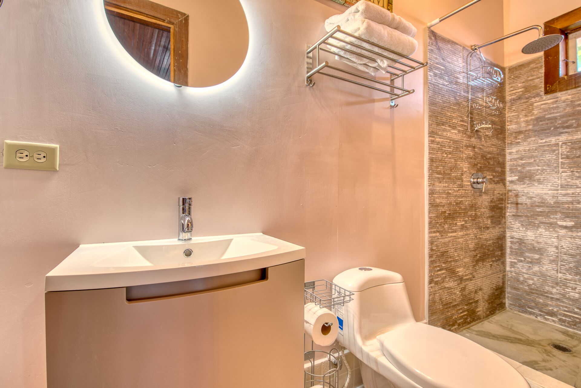 A bathroom with a sink, toilet, and shower.