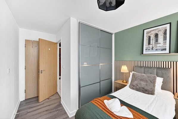 1 bedroom, desk, iron/ironing board, travel crib