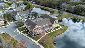 Situated near a serene water body, this charming home offers a peaceful living environment with a front porch and a well-maintained lawn.