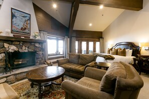 Relax in this elegantly furnished living room with a stone fireplace and comfortable seating area.