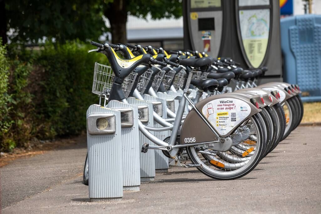 A row of VéloCité bicycles parked in a station.