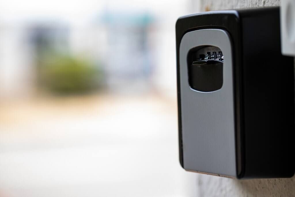 A black intercom device mounted on a wall.