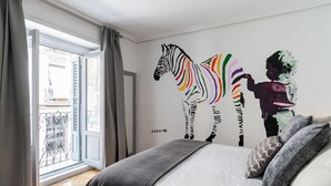 A bedroom with a large window, a zebra mural on the wall, and a bed with pillows. - ART-POP groups, by MONARO***** (Madrid)