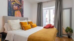 A bedroom with a bed, pillows, a painting, a window with curtains, and a potted plant. - ART-POP groups, by MONARO***** (Madrid)