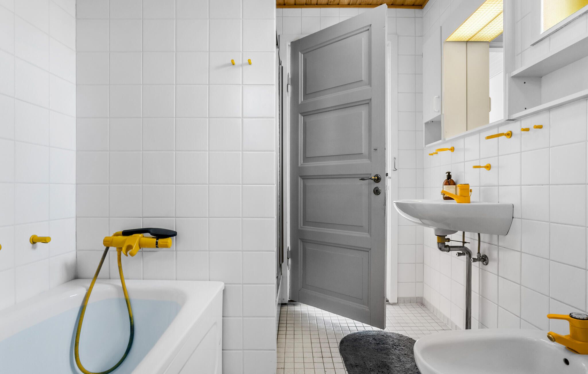 A bathroom with a bathtub, a shower, and a sink.