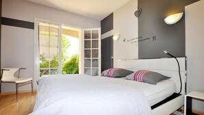 A bedroom with a bed, a chair, a desk, and a wall with a quote. - Lovely home in Limoux (Limoux)