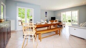 A spacious kitchen with a dining area, large windows, and a TV. - Lovely home in Limoux (Limoux)