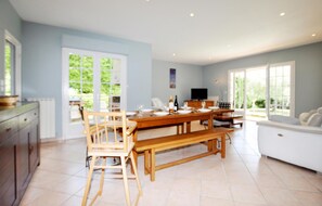 Enjoy meals in the dining area, which features a large table and comfortable seating.