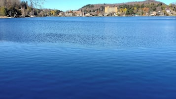 Un lago tranquilo con un muelle de madera en primer plano.