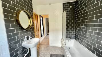Combined shower/bathtub, hair dryer, towels, toilet paper