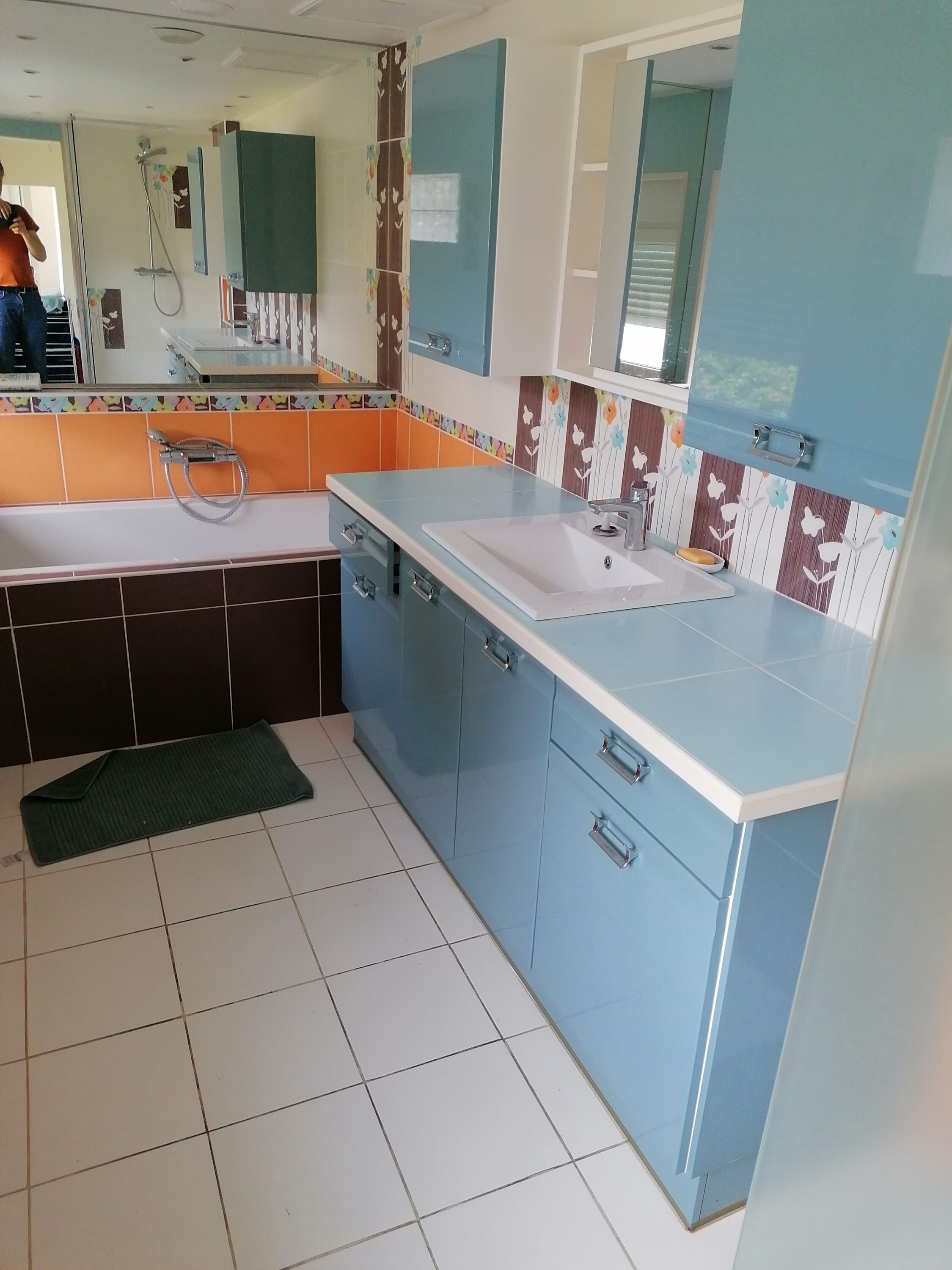 A modern bathroom with a sink, mirror, and shower.