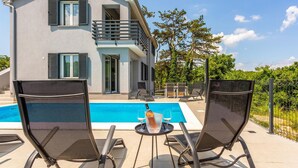 A two-story house with a balcony, a swimming pool, and outdoor seating. - Awesome apartment in Vrbnik with WiFi (Vrbnik)