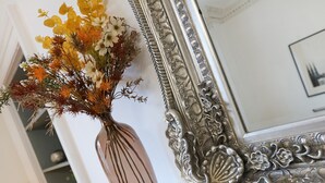 A vase with flowers on a marble surface next to an ornate mirror. - A fabulous 2-bedroom apartment in the heart of Edinburgh (Edinburgh)