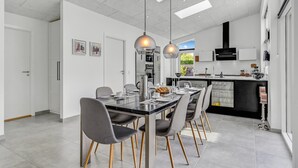 A modern kitchen with a dining area.