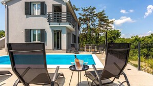 A modern two-story house with a pool, outdoor seating, and a balcony. - 2 bedroom nice apartment in Vrbnik (Vrbnik)