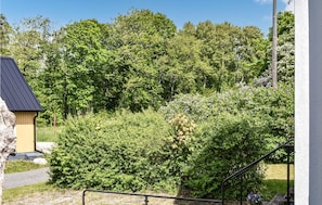 Escape to a serene garden oasis with a tranquil pathway leading to a charming entrance.
