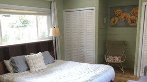 A bedroom with a large bed, a chair, a wardrobe, and a painting on the wall. - Beautiful, private, sunny, ideal location, 31 night minimum (Carmel Valley)