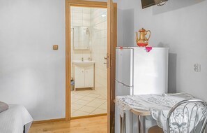 Cozy living space with a kitchenette, bathroom, and comfortable seating area.