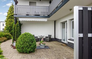 Enjoy the serene views from this building's balcony, featuring a table and chairs, perfect for a quiet moment.
