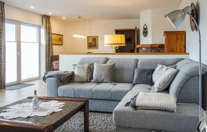 Relax in this stylish living room with a comfortable sofa, coffee table, and floor lamp.