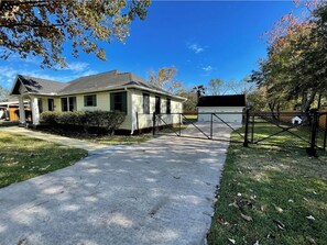 A single-story house with a front yard, a driveway, and a garage.