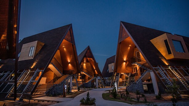 A modern building with multiple triangular roofs and staircases leading to upper levels.