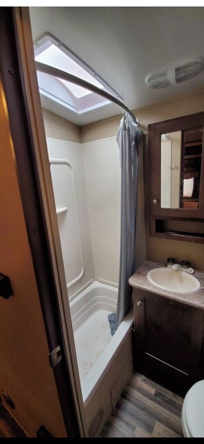 Combined shower/bathtub, hair dryer, soap, toilet paper