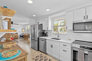 Fridge, microwave, oven, stovetop - Blue Pelican: Sparkling Pool, Patio Dining, Close to the Beach by Anna Maria Life Vacation Rentals (Holmes Beach)