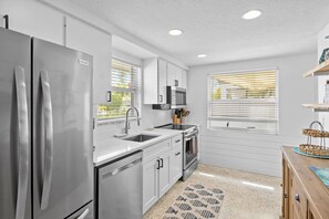 Fridge, microwave, oven, stovetop - Blue Pelican: Sparkling Pool, Patio Dining, Close to the Beach by Anna Maria Life Vacation Rentals (Holmes Beach)