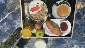 A breakfast tray with yogurt, granola, strawberries, a croissant, coffee, juice, an apple, and jam. - Kimiro Hotel Tsilivi (Zakynthos)